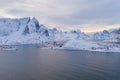 Aerial view of Norwegian fishing village in Reine City, Lofoten islands, Nordland, Norway, Europe. White snowy mountain hills, Royalty Free Stock Photo