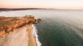 Aerial view of ocean and Nazare lighthouse at sunset, Portugal