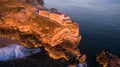 Aerial view of ocean and Nazare lighthouse at sunset, Portugal