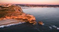 Aerial view of ocean and Nazare lighthouse at sunset, Portugal