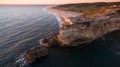 Aerial view of ocean, north Beach and Nazare lighthouse at sunset, Portugal