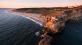 Aerial view of ocean, north Beach and Nazare lighthouse at sunset, Portugal