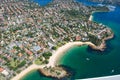 Aerial view of an ocean shoreline with small residential houses in the foreground Royalty Free Stock Photo