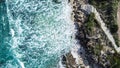 Aerial view ocean surf sea water washing onto sandy shoreline with stairs leading to beach Royalty Free Stock Photo