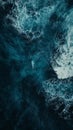 Aerial view of ocean surfer amidst powerful blue waves Royalty Free Stock Photo