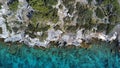 an aerial view of the ocean surrounded by trees and boulders Royalty Free Stock Photo