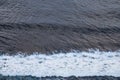 Aerial view of ocean with wave and lonely surfer in blue water Royalty Free Stock Photo