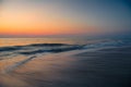 Aerial view of ocean waves breaking beach during sunset Royalty Free Stock Photo