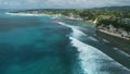 Aerial view of ocean with waves and coastline on Impossibles beach in Bali