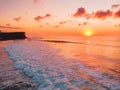 Aerial view of ocean with waves, surfers and sunset in Bali Royalty Free Stock Photo