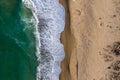 Aerial view of ocean waves washing a sandy shoreline