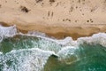 Aerial view of ocean waves washing a sandy shoreline