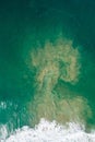 Aerial view of an ocean whirlpool after wave crash