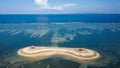 Aerial view of an offshore gazebo protected by a huge, fringing tropical coral reef