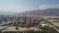 Aerial view, Oil refinery with a background of mountains and sky.The factory is located in the middle of nature and no emissions, Royalty Free Stock Photo