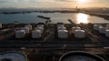 Aerial view oil tanker and oil storage tank terminal port at sunset