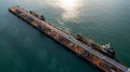 Aerial view oil tanker and oil storage tank terminal port at sunset