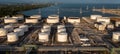 Aerial view oil tanker and oil storage tank terminal port at sunset