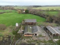 Aerial view of an old and abandoned dairy farm showing the milking parlour and nearby barns. Royalty Free Stock Photo