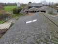 Aerial view of an old and abandoned dairy farm showing the milking parlour and nearby barns. Royalty Free Stock Photo