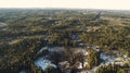 Aerial view of old asphalt road in the spring forest. Snow melts