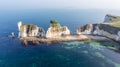 An aerial view of the Old Harry Rocks along the Jurassic coast with crystal clear water and white cliffs under a hazy sky Royalty Free Stock Photo