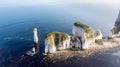 An aerial view of the Old Harry Rocks along the Jurassic coast with crystal clear water and white cliffs under a hazy sky Royalty Free Stock Photo