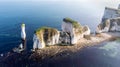 An aerial view of the Old Harry Rocks along the Jurassic coast with crystal clear water and white cliffs under a hazy sky Royalty Free Stock Photo