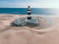 Aerial view of old lighthouse with ocean in background