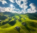 Aerial view of old mountain village on the green hills at sunset Royalty Free Stock Photo