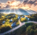 Aerial view of old mountain village on the green hills at sunset Royalty Free Stock Photo