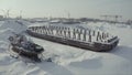 Aerial view of an old pier and a moored rusty ship on a snow covered shore. Clip. Winter landscape of an abandoned pier Royalty Free Stock Photo