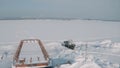 Aerial view of an old pier and a moored rusty ship on a snow covered shore. Clip. Winter landscape of an abandoned pier Royalty Free Stock Photo