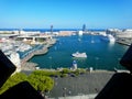 Aerial view the old port of Barcelona on a clear sunny day. Large cruise ships are moored to the pier. Royalty Free Stock Photo