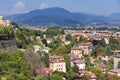 Aerial view of the old town Bergamo in northern Italy with red tiled roofs of houses on the background of the Alpine mountains. Royalty Free Stock Photo