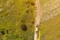 Aerial view of old tractor with trailer on country road Royalty Free Stock Photo
