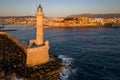 Aerial view of the old Venetian era lighthouse in the harbor of Chania at sunset (Crete, Greece
