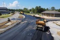 Aerial view of ongoing asphalt paving project featuring geometric road patterns and infrastructure