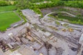 Aerial view of open cast mining panorama quarry with lots of machinery at work equipment at a plant