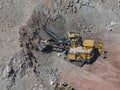 Aerial view of an open-pit mine in the process of mineral extraction with heavy machinery Royalty Free Stock Photo