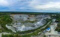 Aerial view of opencast mining quarry with lots of machinery at work - view from above