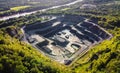 Aerial view of opencast mining quarry in the middle of the forest Royalty Free Stock Photo
