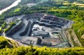 Aerial view of opencast mining quarry in the middle of the forest