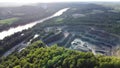 Aerial view of opencast mining quarry in the middle of the forest