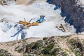 Aerial view of opencast mining quarry with one machinery on the blue sea background. Royalty Free Stock Photo