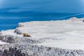 Aerial view of opencast mining quarry with one machinery on the blue sea background. Royalty Free Stock Photo