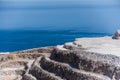 Aerial view of opencast mining quarry with one machinery on the blue sea background. Royalty Free Stock Photo