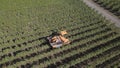 Aerial view of an orange combiner tractor in a farmland Royalty Free Stock Photo