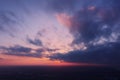 Aerial view of an orange or pink sky, a beautiful sunset, the clouds are highlighted with bright light.Evening time Royalty Free Stock Photo