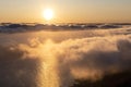 Aerial view of an orange sunrise sunset over a cloud layer the Pico - SÃÂ£o Jorge Channel, the piece of Atlantic Ocean in between